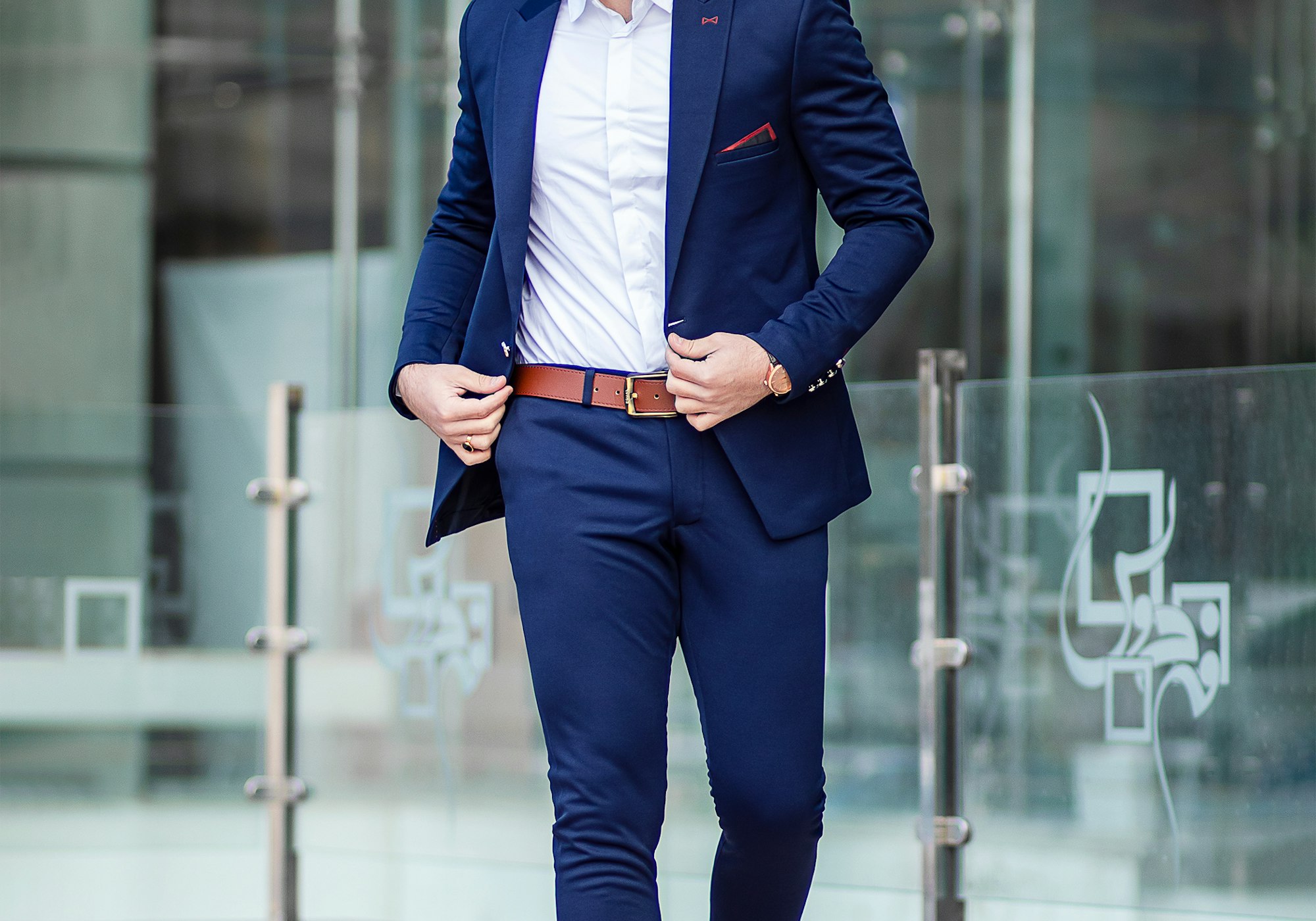 Man in a tailored charcoal business suit, architectural setting